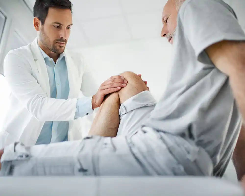 Closeup side view of an early 60's senior gentleman having some knee pain.